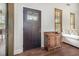 Welcoming entryway with a dark wood door, decorative cabinet, hardwood floors, and natural light at 221 Lander Dr., Conway, SC 29526