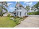 Charming two-story home with a covered front porch, beautiful flower beds, and a long driveway at 221 Lander Dr., Conway, SC 29526