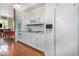 Bright kitchen features white cabinetry, stainless appliances, and wood-look tile flooring at 221 Lander Dr., Conway, SC 29526