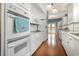 This kitchen features white cabinets, granite countertops, wood-look flooring, and stainless appliances at 221 Lander Dr., Conway, SC 29526