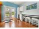 Cozy kitchen area features white cabinetry, a wine refrigerator, and a dining area with access to the yard at 221 Lander Dr., Conway, SC 29526