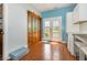 This kitchen area has wood-look tile flooring, white cabinets, and access to the backyard at 221 Lander Dr., Conway, SC 29526