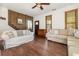 Comfortable living room featuring hardwood floors, a white sofa, wood wall paneling, and natural light at 221 Lander Dr., Conway, SC 29526