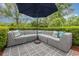 A lovely outdoor patio with a large sectional sofa and an umbrella for shade at 221 Lander Dr., Conway, SC 29526