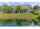 Backyard of a home featuring a screened-in porch, pond, and a fenced in yard at 246 Laurel Bay Dr., Murrells Inlet, SC 29576