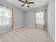 Neutral-toned bedroom with carpet, windows, ceiling fan, and bright natural light at 246 Laurel Bay Dr., Murrells Inlet, SC 29576