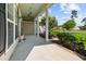 Inviting front porch with white columns, ceiling fan, and beautiful landscaping at 246 Laurel Bay Dr., Murrells Inlet, SC 29576