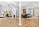 Open-concept living area featuring wood floors, pillars, neutral paint, and a connected home office space at 246 Laurel Bay Dr., Murrells Inlet, SC 29576