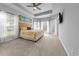 Spacious main bedroom boasts a tray ceiling, many windows, and beach-themed decor creating a relaxing coastal vibe at 246 Laurel Bay Dr., Murrells Inlet, SC 29576