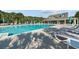 Large community pool surrounded by lounge chairs, tables and palm trees at 246 Laurel Bay Dr., Murrells Inlet, SC 29576