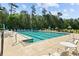 Community pool with seating and umbrellas surrounded by trees at 246 Laurel Bay Dr., Murrells Inlet, SC 29576