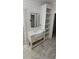 Bathroom with a farmhouse sink, a dark-framed mirror, and a built-in storage shelf at 25 Pinewood Dr., Carolina Shores, SC 28467