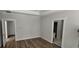This is an empty bedroom with views into the hallway and closet space, featuring wood-look floors at 25 Pinewood Dr., Carolina Shores, SC 28467