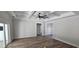Spacious bedroom with coffered ceilings, a ceiling fan, neutral walls, and wood-look floors at 25 Pinewood Dr., Carolina Shores, SC 28467