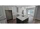 Kitchen island with a marble countertop, white cabinetry, and modern pendant lighting at 25 Pinewood Dr., Carolina Shores, SC 28467