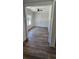 Spacious room with stylish wood-look flooring, complemented by bright white trim and wainscoting at 25 Pinewood Dr., Carolina Shores, SC 28467