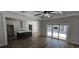 Open-concept space with wood-look floors that connects the living room to the kitchen and glass doors at 25 Pinewood Dr., Carolina Shores, SC 28467