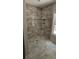 A tile shower featuring marble-look walls, a tiled floor, and a functional built-in niche at 25 Pinewood Dr., Carolina Shores, SC 28467