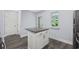 A granite countertop island offers additional storage space, complete with a view of the outdoors at 2728 Mercer Dr. # 2728, Conway, SC 29526