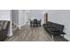 Spacious living room with wood-look flooring, ceiling fan, comfortable seating, and a dining area at 2728 Mercer Dr. # 2728, Conway, SC 29526