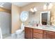 Bright bathroom featuring a double vanity, round window, and a shower with curtain at 276 Waterfall Circle, Little River, SC 29566