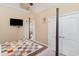 Bedroom with large window, vaulted ceiling, neutral paint and a peek into the living area at 276 Waterfall Circle, Little River, SC 29566