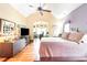 Spacious bedroom featuring wood floors, high ceilings, and a view to the connected home office at 276 Waterfall Circle, Little River, SC 29566