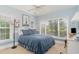 Bright bedroom features a large window, blue walls, and a bed with blue linens and decorative pillows at 276 Waterfall Circle, Little River, SC 29566