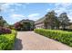 Beautiful brick home featuring a paver driveway and meticulously manicured landscaping at 276 Waterfall Circle, Little River, SC 29566