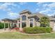 Lovely brick home showcasing a pergola-covered patio, manicured lawn, and lush landscaping at 276 Waterfall Circle, Little River, SC 29566