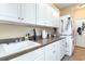 Functional laundry room with ample counter space, built-in cabinets, and a stacked washer/dryer at 276 Waterfall Circle, Little River, SC 29566