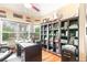 Well-lit office with custom shelving, a large desk, and a bright window at 276 Waterfall Circle, Little River, SC 29566