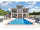 Community pool with a large sun deck, lounge chairs and well-maintained landscaping at 276 Waterfall Circle, Little River, SC 29566