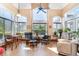 Bright sunroom with large windows, comfortable seating, and tile flooring at 276 Waterfall Circle, Little River, SC 29566