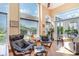 Bright sunroom with tile flooring, comfortable seating, and large windows offering natural light at 276 Waterfall Circle, Little River, SC 29566