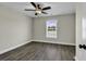 Inviting bedroom with a ceiling fan, large window and wood-look floors, offering a cozy and serene atmosphere at 2919 Hughes Gasque Rd., Aynor, SC 29511