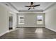 A spacious bedroom with tray ceiling, ceiling fan and wood-look flooring at 2919 Hughes Gasque Rd., Aynor, SC 29511