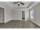 Spacious bedroom featuring modern tray ceilings, wood-look floors, and a ceiling fan for optimal comfort at 2919 Hughes Gasque Rd., Aynor, SC 29511