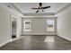 A spacious bedroom with tray ceiling, ceiling fan and wood-look flooring at 2919 Hughes Gasque Rd., Aynor, SC 29511