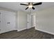 Comfortable bedroom with a ceiling fan, a large window, wood-look floors, and double closets, offering a welcoming retreat at 2919 Hughes Gasque Rd., Aynor, SC 29511