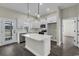 Modern kitchen featuring white cabinets, stainless appliances, quartz countertops, and stylish pendant lighting at 2919 Hughes Gasque Rd., Aynor, SC 29511