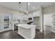 Modern kitchen featuring white cabinets, stainless appliances, quartz countertops, and stylish pendant lighting at 2919 Hughes Gasque Rd., Aynor, SC 29511