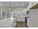 Modern kitchen featuring white cabinets, stainless appliances, quartz countertops, and stylish pendant lighting at 2919 Hughes Gasque Rd., Aynor, SC 29511