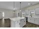 Modern kitchen with a large island, white cabinets, stainless appliances, and open access to the living area at 2919 Hughes Gasque Rd., Aynor, SC 29511