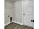 Laundry room featuring hardwood floors, wire shelving and a white interior door at 2919 Hughes Gasque Rd., Aynor, SC 29511