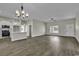 Open-concept living area featuring modern kitchen and a light-filled living space with hardwood floors at 2919 Hughes Gasque Rd., Aynor, SC 29511