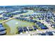 Aerial view of a community with numerous homes surrounding a beautiful lake with fountains at 3024 Calusa Dr., Little River, SC 29566