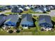 An aerial view of the backyard of the property, with a sunroom and manicured yard at 3024 Calusa Dr., Little River, SC 29566