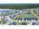 Aerial view of a Primary-planned community surrounding multiple ponds and lush trees at 3024 Calusa Dr., Little River, SC 29566