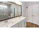 Bright primary bathroom with double vanity, lots of counter space, and a tiled walk in shower at 3024 Calusa Dr., Little River, SC 29566